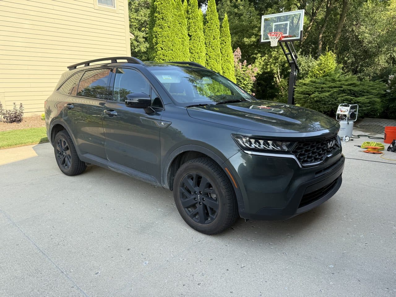 A clean, glossy SUV after a full detail in a driveway
