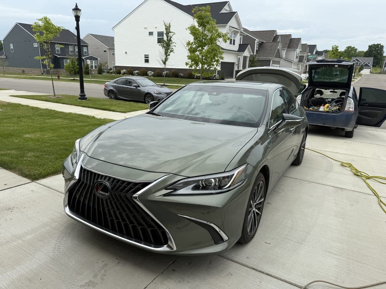 A freshly detailed sedan gleaming in a driveway after a mobile detail